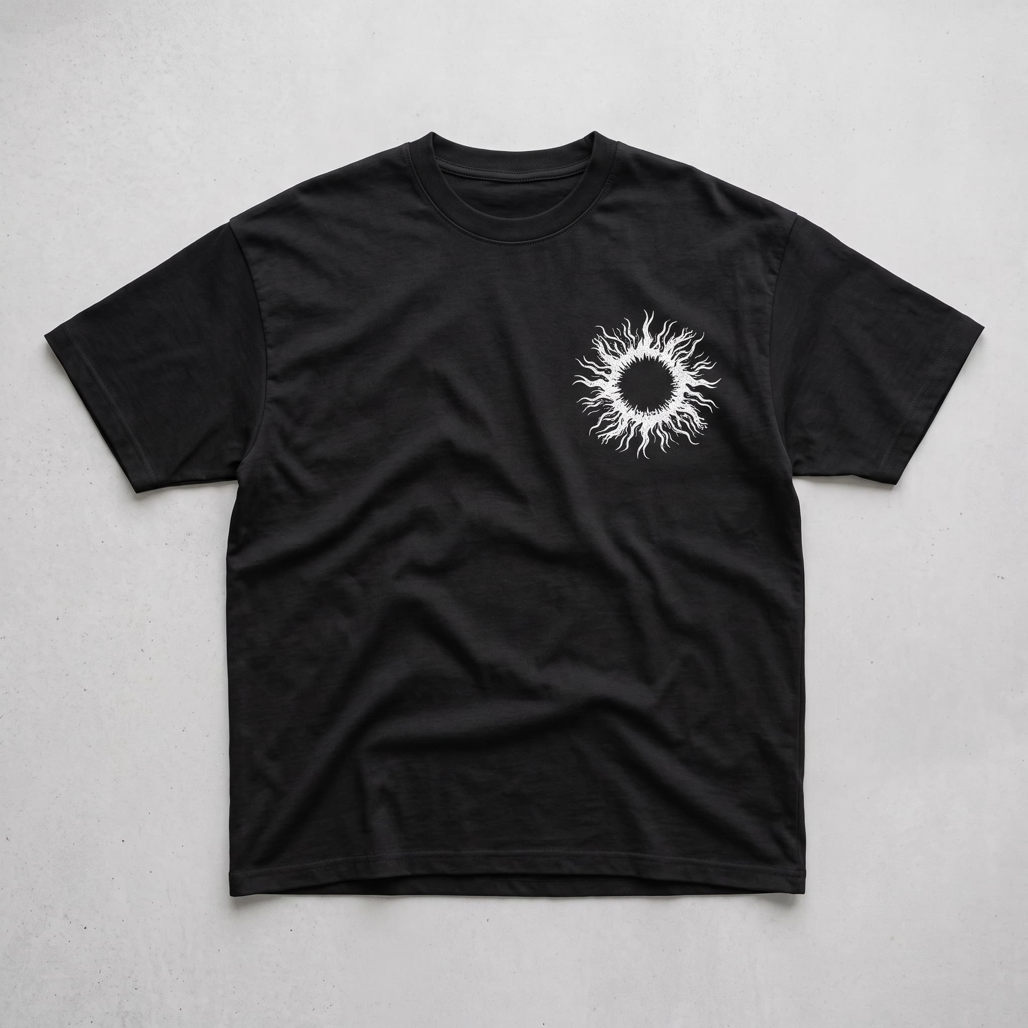 Front of the black Icarus Descent T-shirt with a white eclipsed sun chest graphic